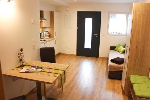 a small room with a table and a door at Appartements Pixner in Saltusio