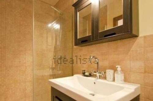 a bathroom with a sink and a shower and a mirror at Peace & Rest in Pirineus in Latour-de-Carol