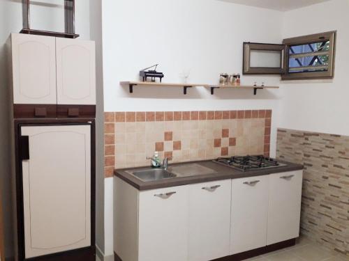 a kitchen with a sink and a stove at Liberty House in Marsala