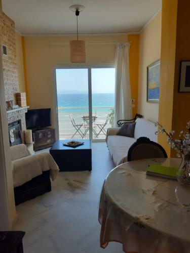 a living room with a view of the ocean at Apartment Michalis by the Sea in Artemida