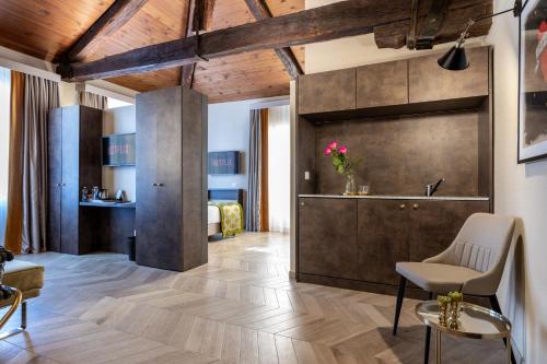 a living room with wooden ceilings and a large wall at NEMAN Maison Experience I Pantheon in Rome