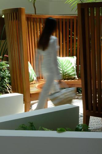 a woman walking on a porch with at Azia Resort & Spa in Paphos City