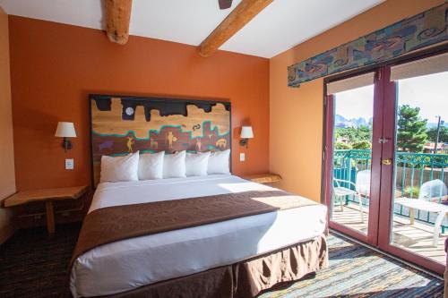 a bedroom with a large bed and a balcony at Southwest Inn at Sedona in Sedona
