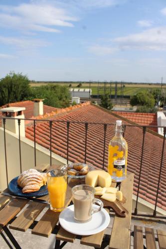 een tafel met ontbijt en een fles sinaasappelsap bij Casa da Rainha in Azambuja