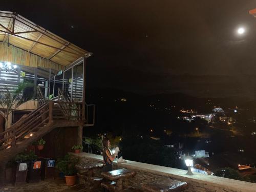 a building with a balcony at night with the moon at Cabinas Vista Al Golfo in Monteverde Costa Rica