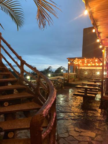 a group of wooden benches and a building with lights at Cabinas Vista Al Golfo in Monteverde Costa Rica