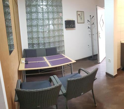 a ping pong table and chairs in a room at Apartment Anita in Fažana