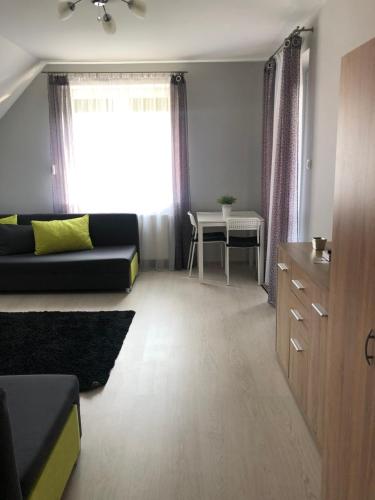 a living room with a couch and a table at Domek na Jasnej in Muszyna