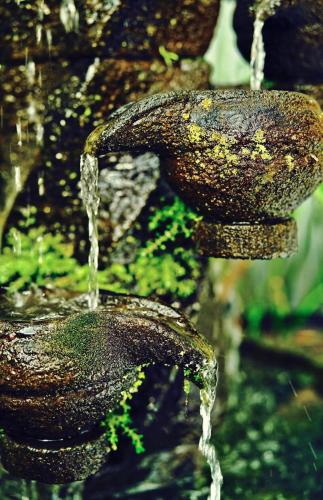 a stream of water coming out of a fountain at Rumah Desa Homestay in Prambanan