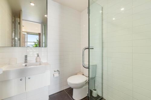 a bathroom with a toilet and a sink and a shower at Horoeka on Hallenstein in Queenstown