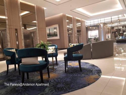 a lobby with chairs and tables in a store at The Paneya@Anderson Apartment in Surabaya