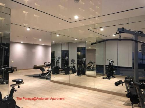 a gym with treadmills and exercise equipment in a room at The Paneya@Anderson Apartment in Surabaya