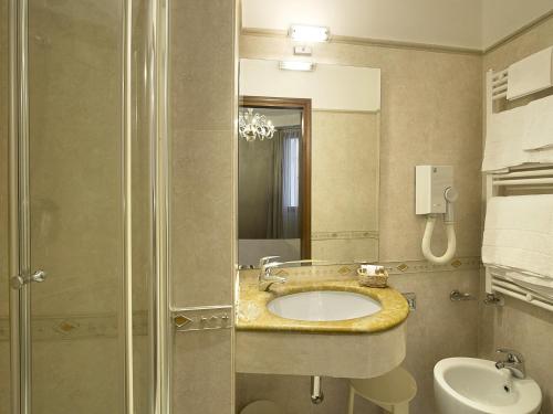 a bathroom with a sink and a shower at Hotel Campiello in Venice