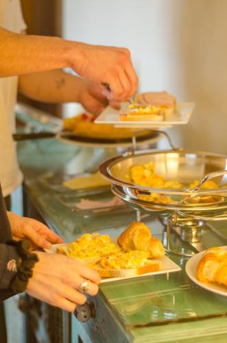 a group of people preparing food at a buffet at Hotel Boutique Cutipay in Valdivia