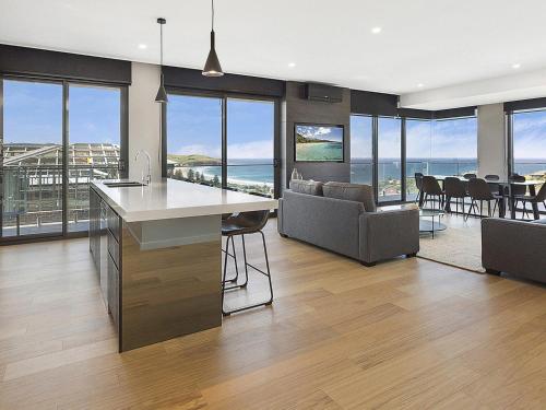 a kitchen and living room with a view of the ocean at Cosmopolitan at SoHo in Gerringong