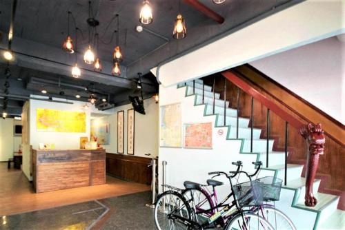 two bikes parked next to a staircase in a building at DongNing Atlas Hotel in Tainan
