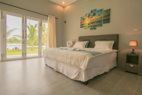 a bedroom with a bed with a teddy bear on it at The Hawk's Nest Resort in Sabang