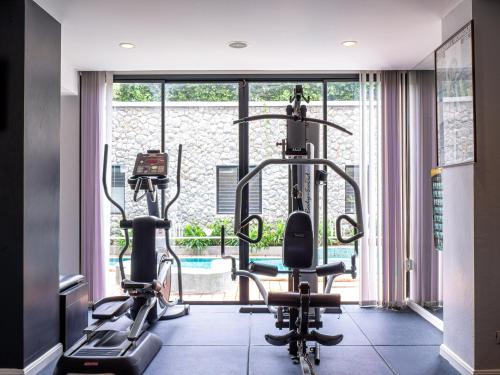 a gym with two treadmills and two exercise bikes at Deevana Plaza Krabi Aonang - SHA Extra Plus in Ao Nang Beach