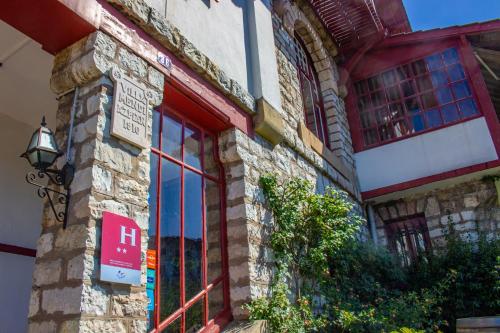 a brick building with a window and a sign on it at Hotel Bellevue in Hendaye