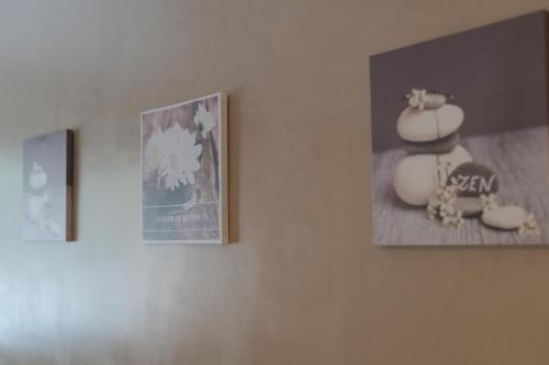 three pictures hanging on a wall in a room at Nid à bulles - Loft 35m2 sauna jacuzzi 10min centre Strasbourg in Bischheim