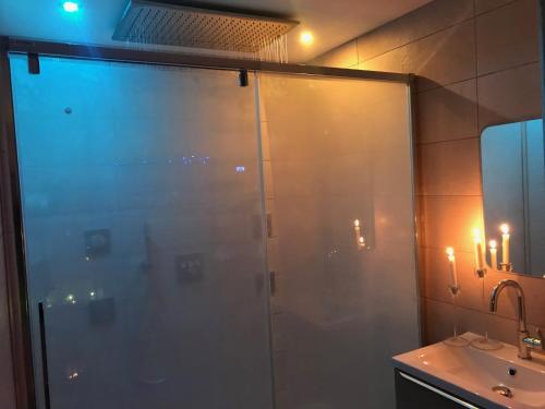 a shower with a glass door in a bathroom at Nid à bulles - Loft 35m2 sauna jacuzzi 10min centre Strasbourg in Bischheim