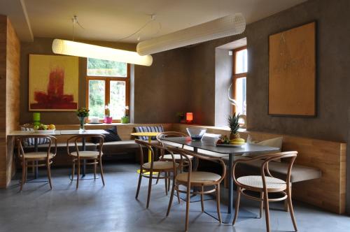 a dining room with a table and chairs at Hotel Kokořín in Kokořín