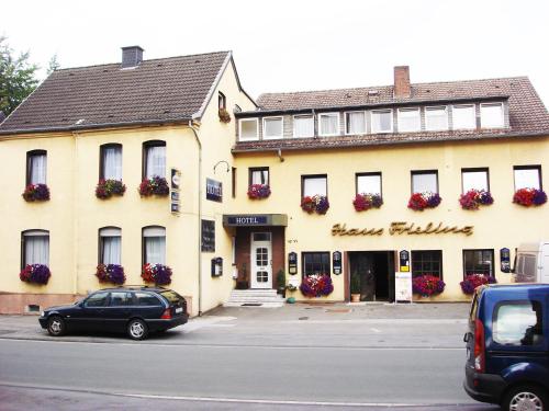 a large yellow building with flowers on the windows at Hotel Haus Frieling in Dortmund
