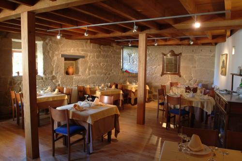 um restaurante com mesas e cadeiras num quarto em Casa Rural Vilaboa em Allariz