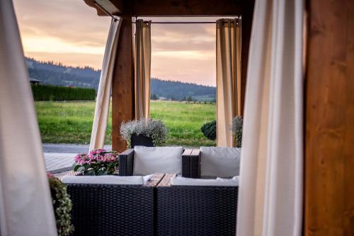 a room with a couch and a window at Silverton -sauna,jacuzzi,mini siłownia,bar sezonowy, przyjazny rodzinom in Białka Tatrzanska