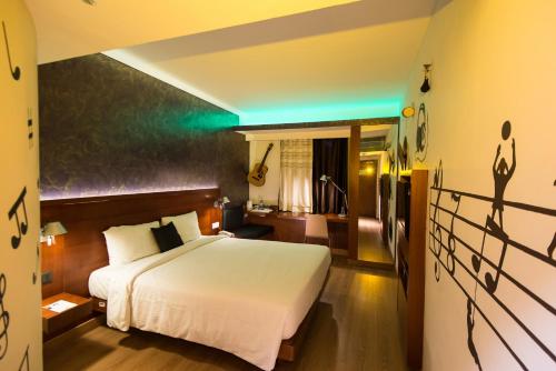 a bedroom with a white bed and a green light at ibis New Delhi Aerocity - An Accor Brand in New Delhi
