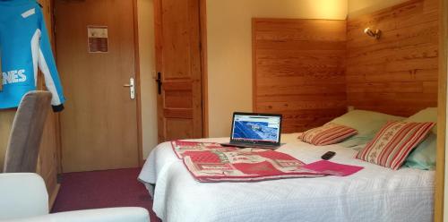 a laptop computer sitting on top of a bed at Le Dôme in Tignes