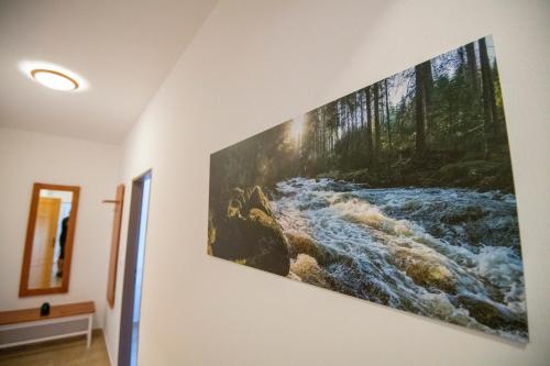 a painting of a river on a wall at Penzion Kryštof in Kovářská