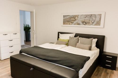 a bedroom with a large bed with a black headboard at Brehm Living in Kandel