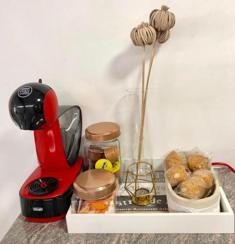 a red blender sitting on top of a shelf with food at CHUECA Apartamentos Noxi in Madrid