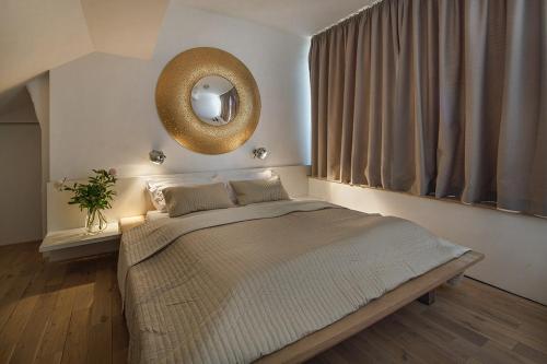 a bedroom with a bed and a mirror on the wall at Holečkova Apartments in Prague