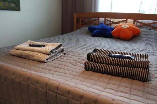 łóżko z dwoma ręcznikami i wypchanym zwierzakiem w obiekcie City centre apartment Siilinjärvi w mieście Siilinjärvi