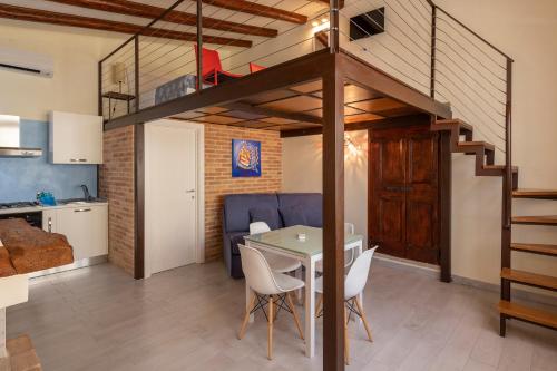 a kitchen and dining room with a loft bed at Agriturismo Monte Cologna in Foligno