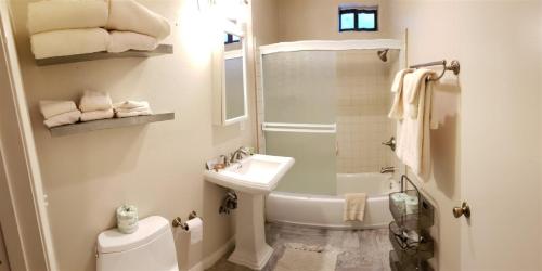 a white bathroom with a sink and a toilet at Birch Creek #8 - 2BR/1.5BA in June Lake