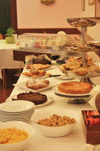 a buffet with many different types of food on a table at La Pineta Dei Liberti in Lido dei Pini