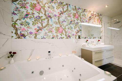 a bathroom with a bath tub and a sink at Grange Boutique Hotel in Grange Over Sands