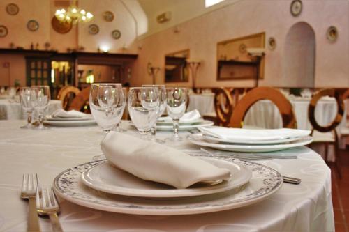 a table with plates and wine glasses on it at La Pineta Dei Liberti in Lido dei Pini