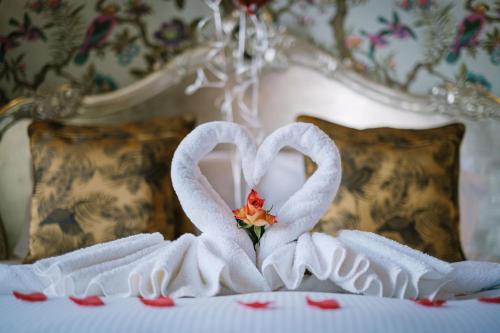 two swans made out of towels on a bed at Grange Boutique Hotel in Grange Over Sands