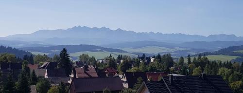 a view of a town with mountains in the background at Noclegi Barbara in Czorsztyn