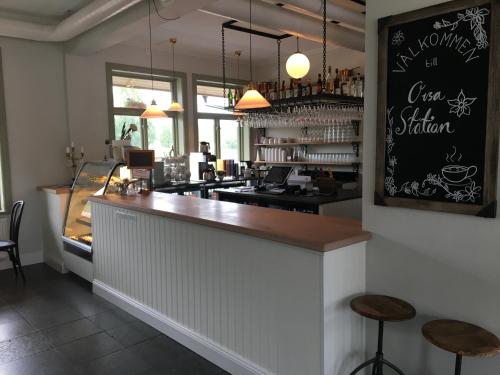 a bar in a restaurant with two stools at Orsa Station Bed and Breakfast in Orsa