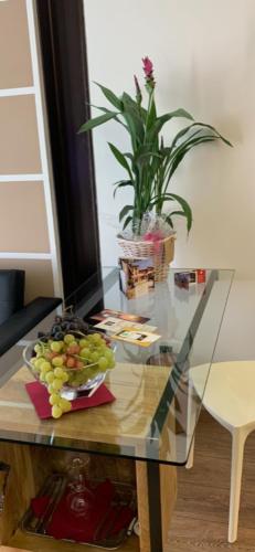 a glass table with a bowl of fruit on it at Luna Residence Hotel in Casalmaggiore