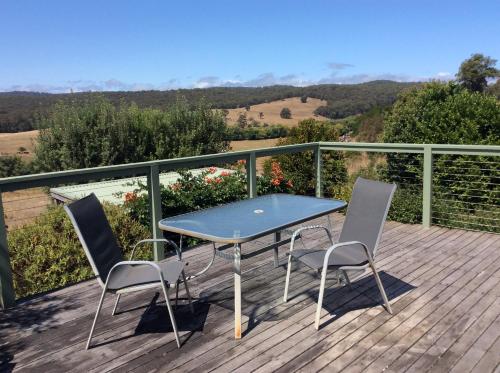 a table and two chairs on a deck with a view at Forrest River Valley- Blue Wren Studio in Forrest