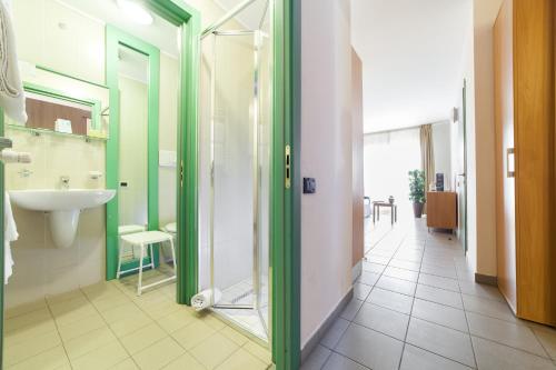 a bathroom with a sink and a glass door at TH Sestriere - Villaggio Olimpico in Sestriere