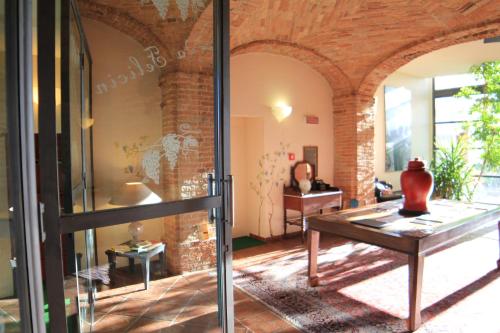 a room with a table with a vase on it at Felicin - Palazzo Boeri Panoramic Suites in Monforte dʼAlba