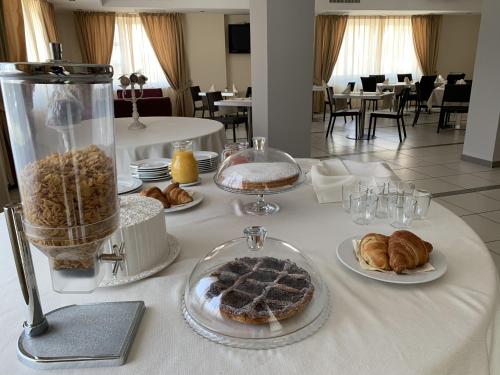 a table with various pastries and breads on it at Hotel Palace Gioia Tauro in Gioia Tauro