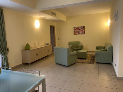 a hospital waiting room with chairs and a table at Hotel Palace Gioia Tauro in Gioia Tauro